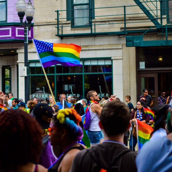 people gathered near building holding flag at daytime